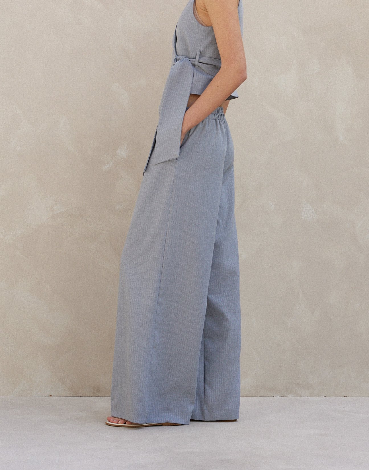 Pinstripe trousers with pleats